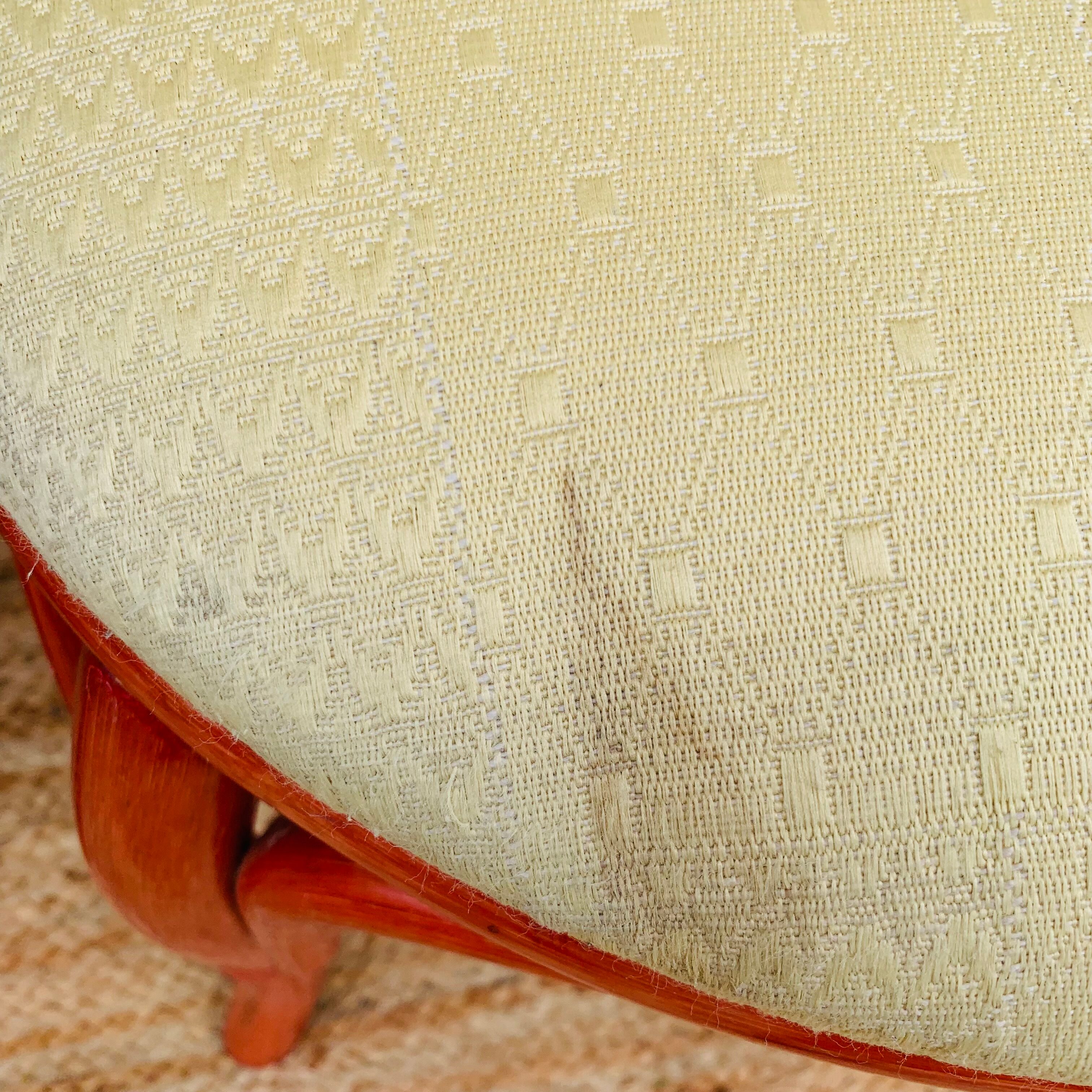 Pair of red rattan chairs and fabric