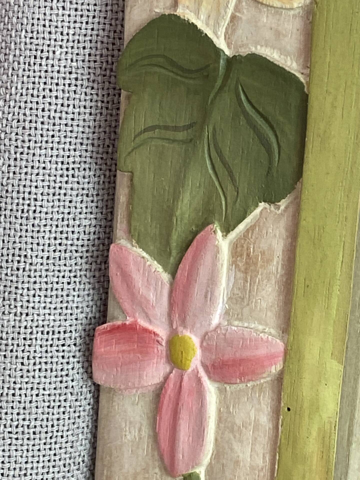 Carved wooden mirror, colourful floral decoration.