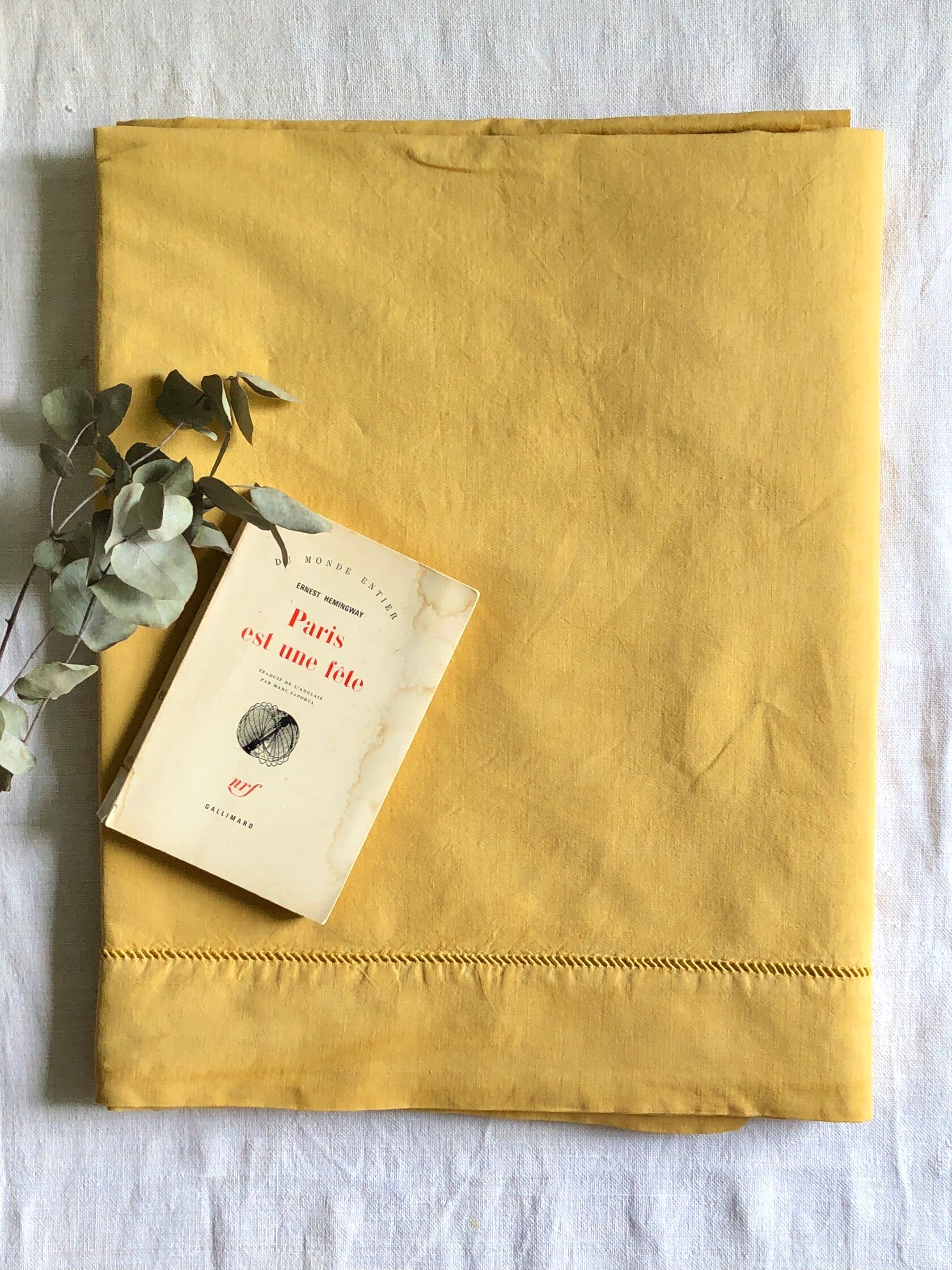 Old linen and cotton sheet tinted in curry yellow