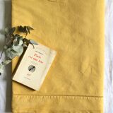 Old linen and cotton sheet tinted in curry yellow