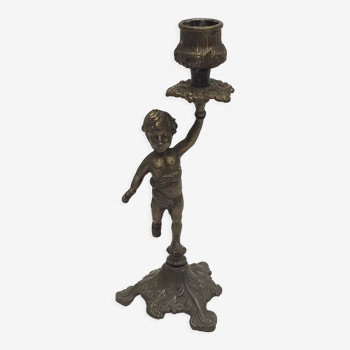 Old candle holder in brass cherub