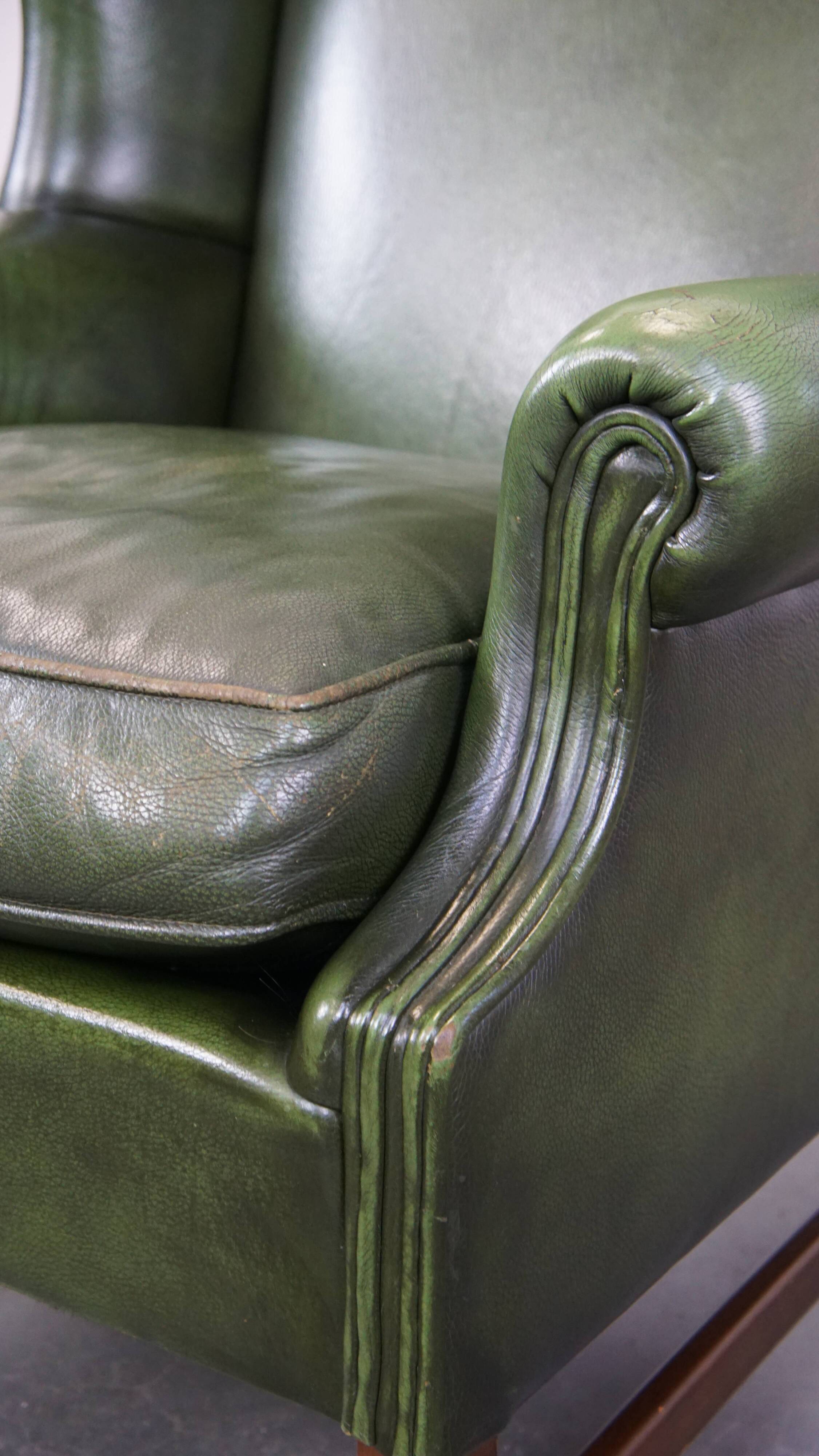 Fauteuil à oreilles Chesterfield anglais en cuir de vache vert avec une assise confortable