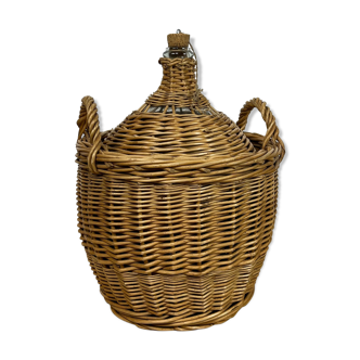 Old demijohn in her wicker basket