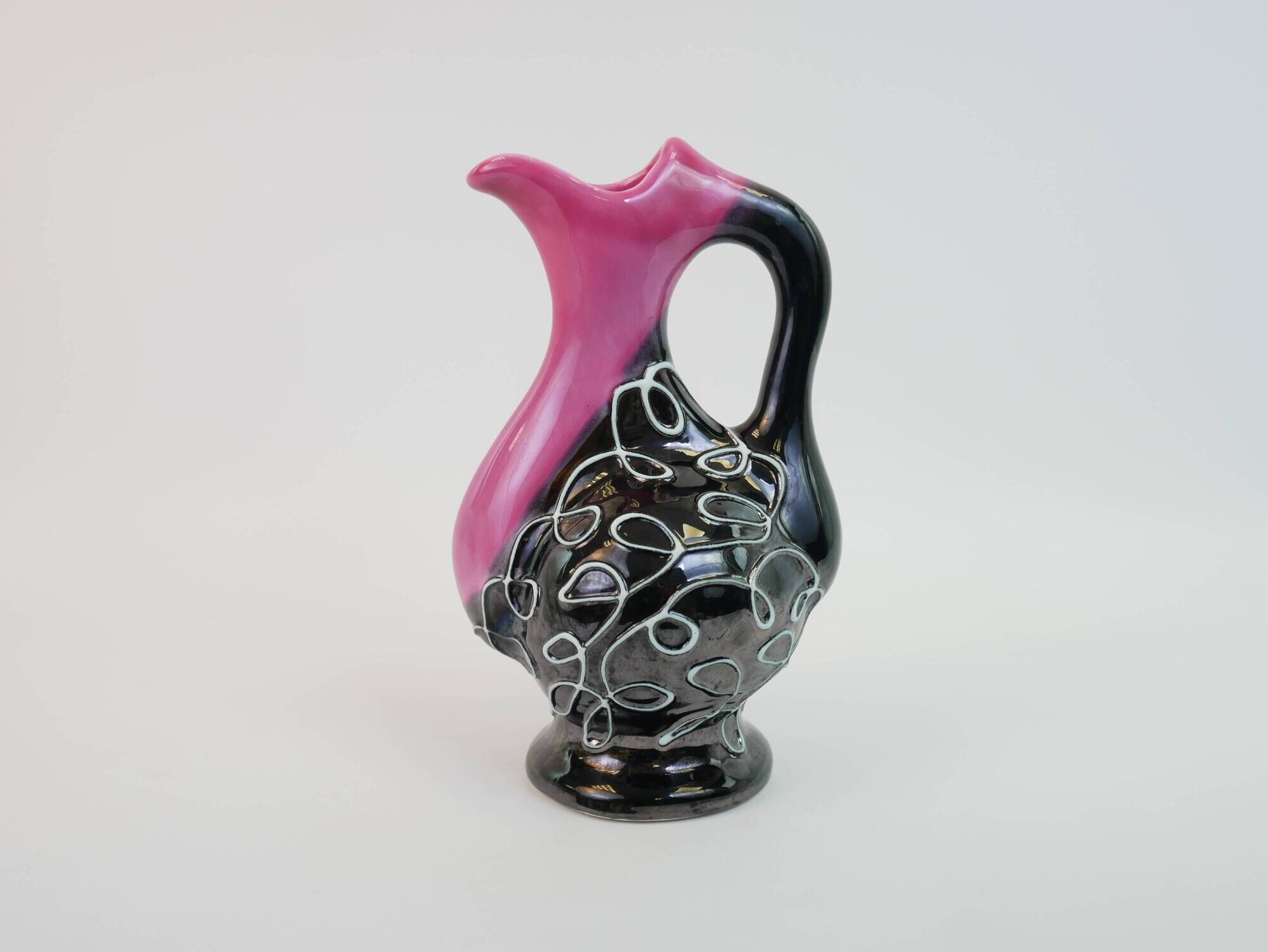 Black and pink Vallauris carafe with white relief patterns