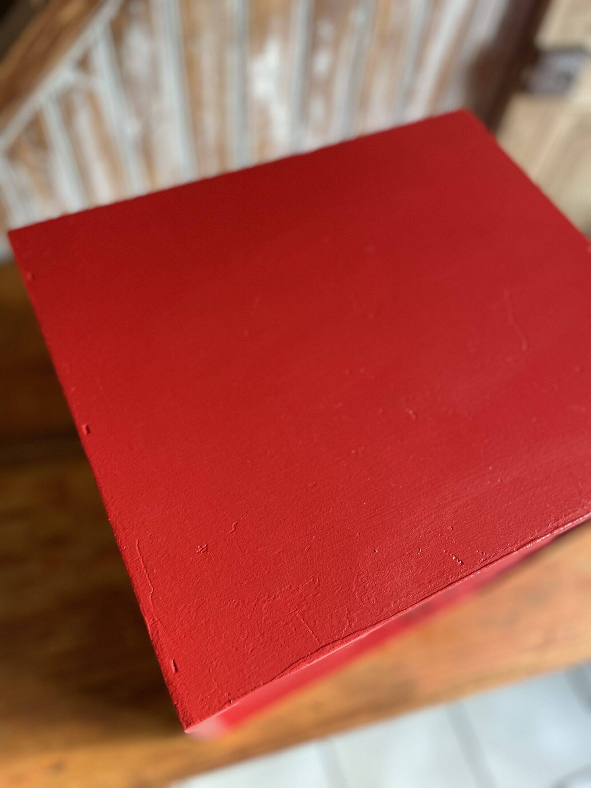 Vintage wooden magazine rack in red.