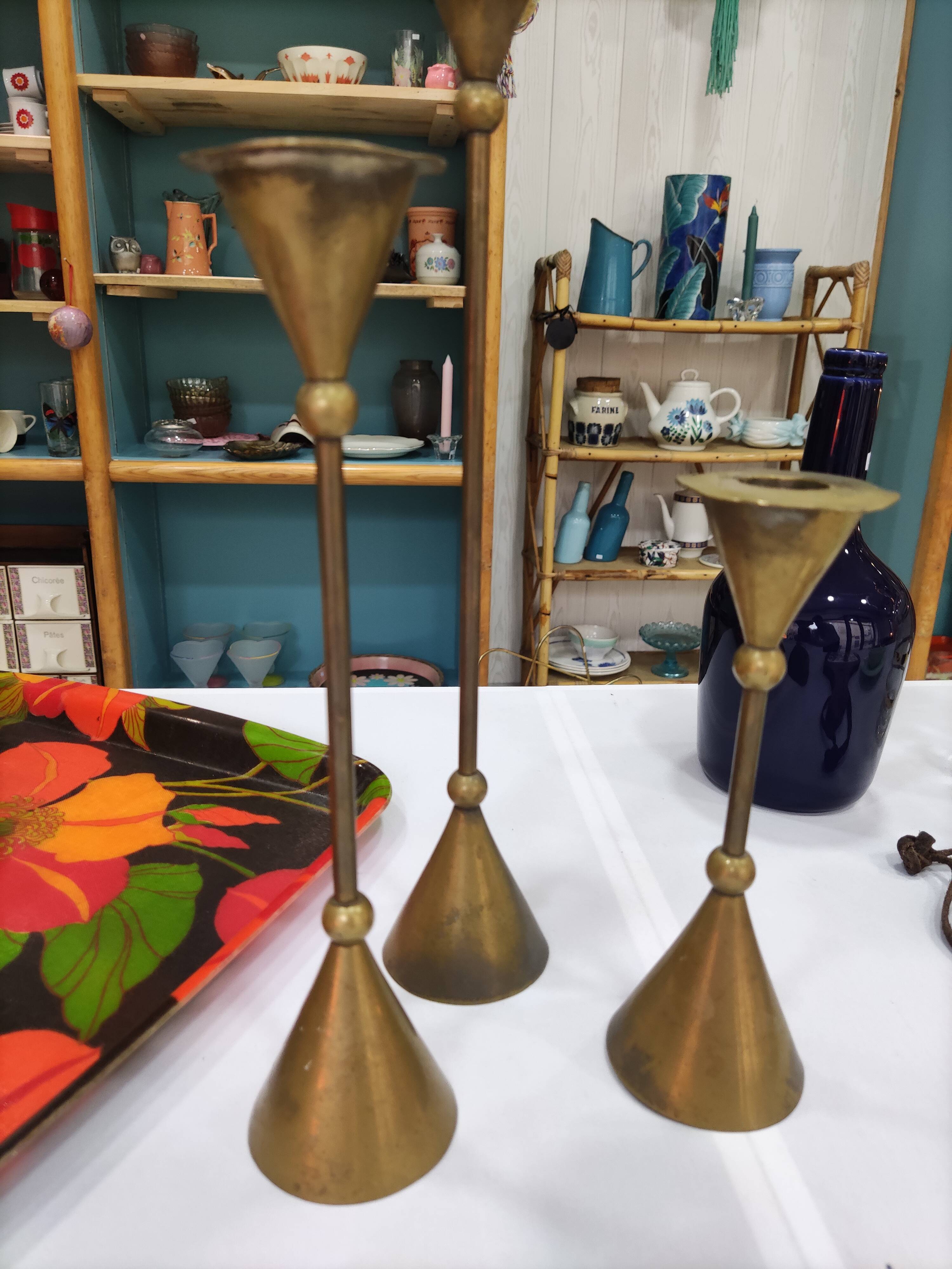 Trio of brass candlesticks design year 70