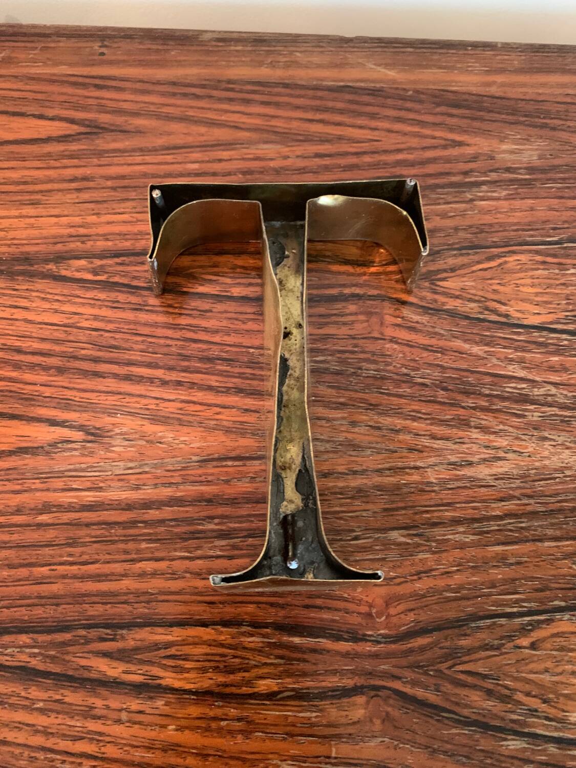 Golden sign letter “T”