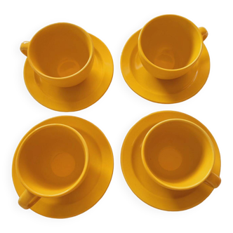 4 yellow cups and saucers