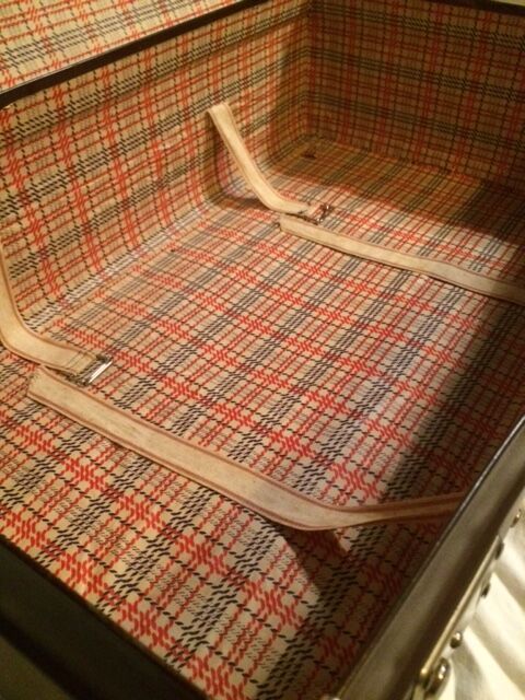 Suitcase vintage leather inside and brown carpeted home