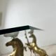 Hollywood Regency style coffee table, 6 patinated brass horses and glass top, 1970.