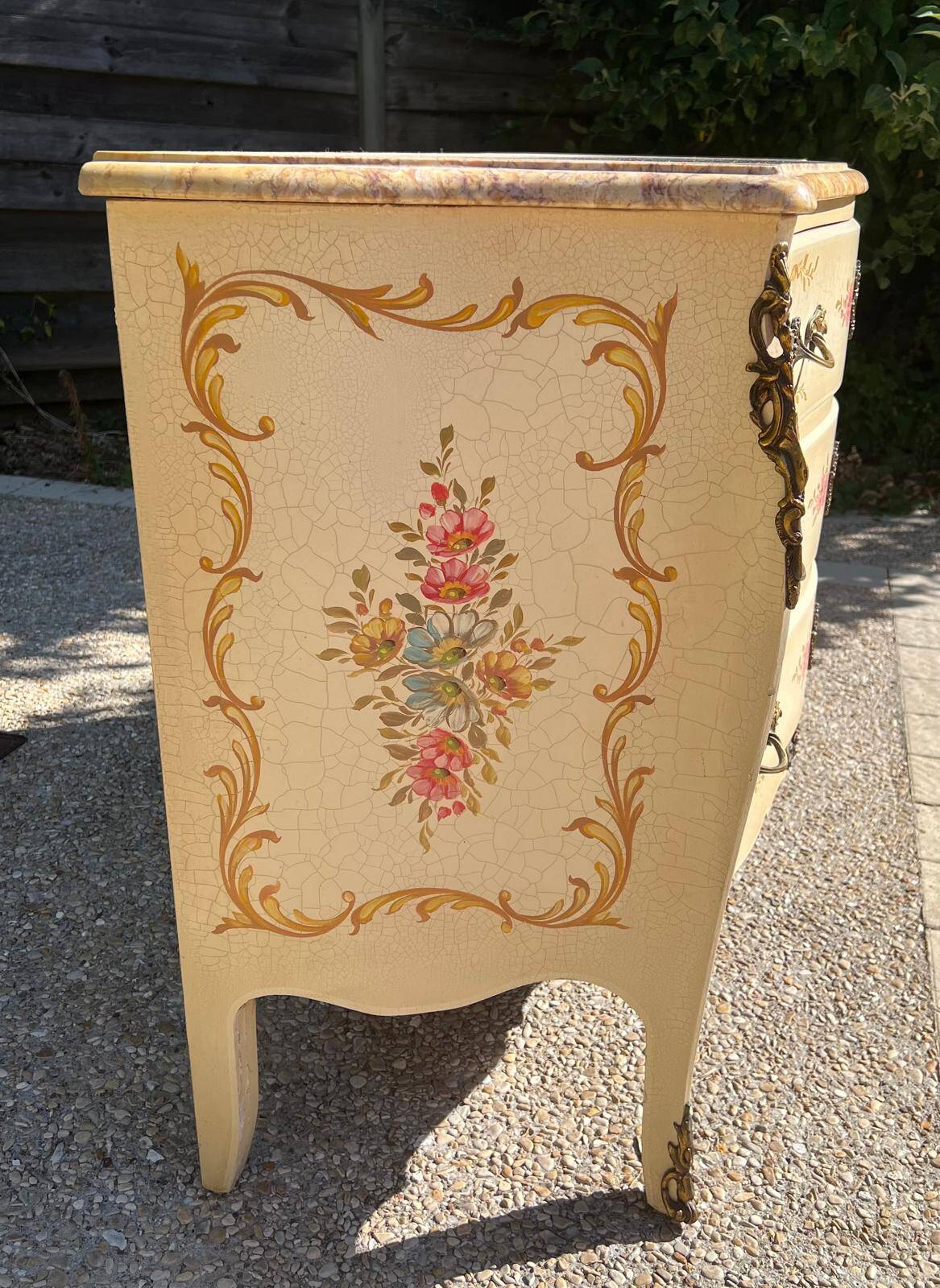 Curved Louis XV style commode in marble with painted floral decoration.