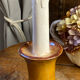 Candle holder-style lamp made entirely of ceramic.