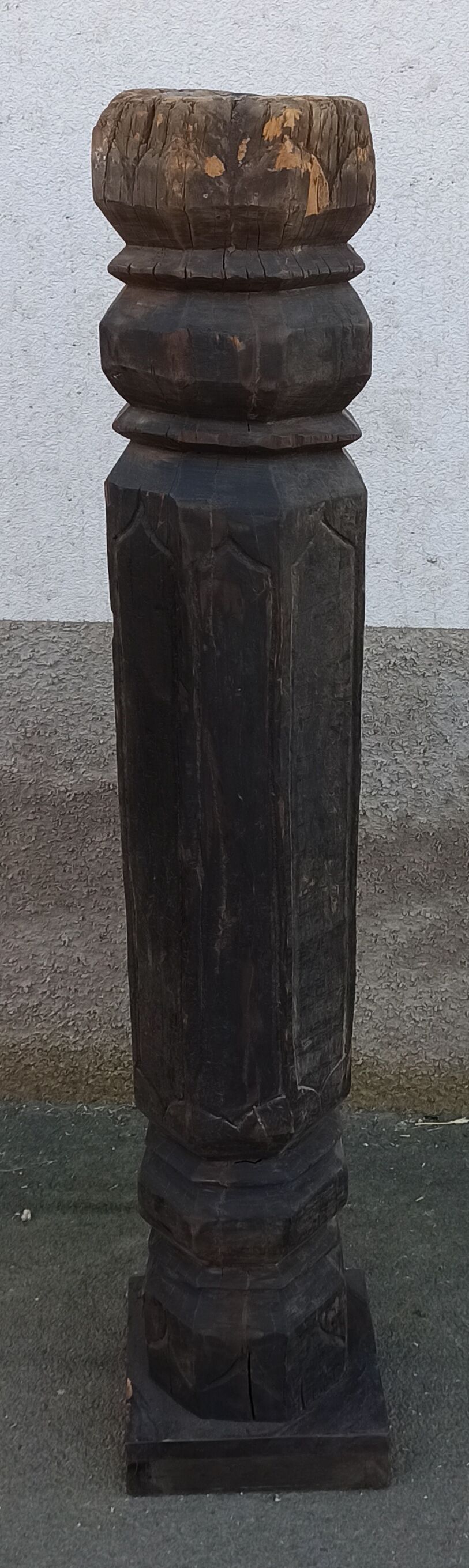 Old wooden pillar on pedestal