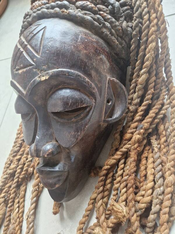 Chokwe Mwana Pwo mask in carved wood with a dark patina and rope hair