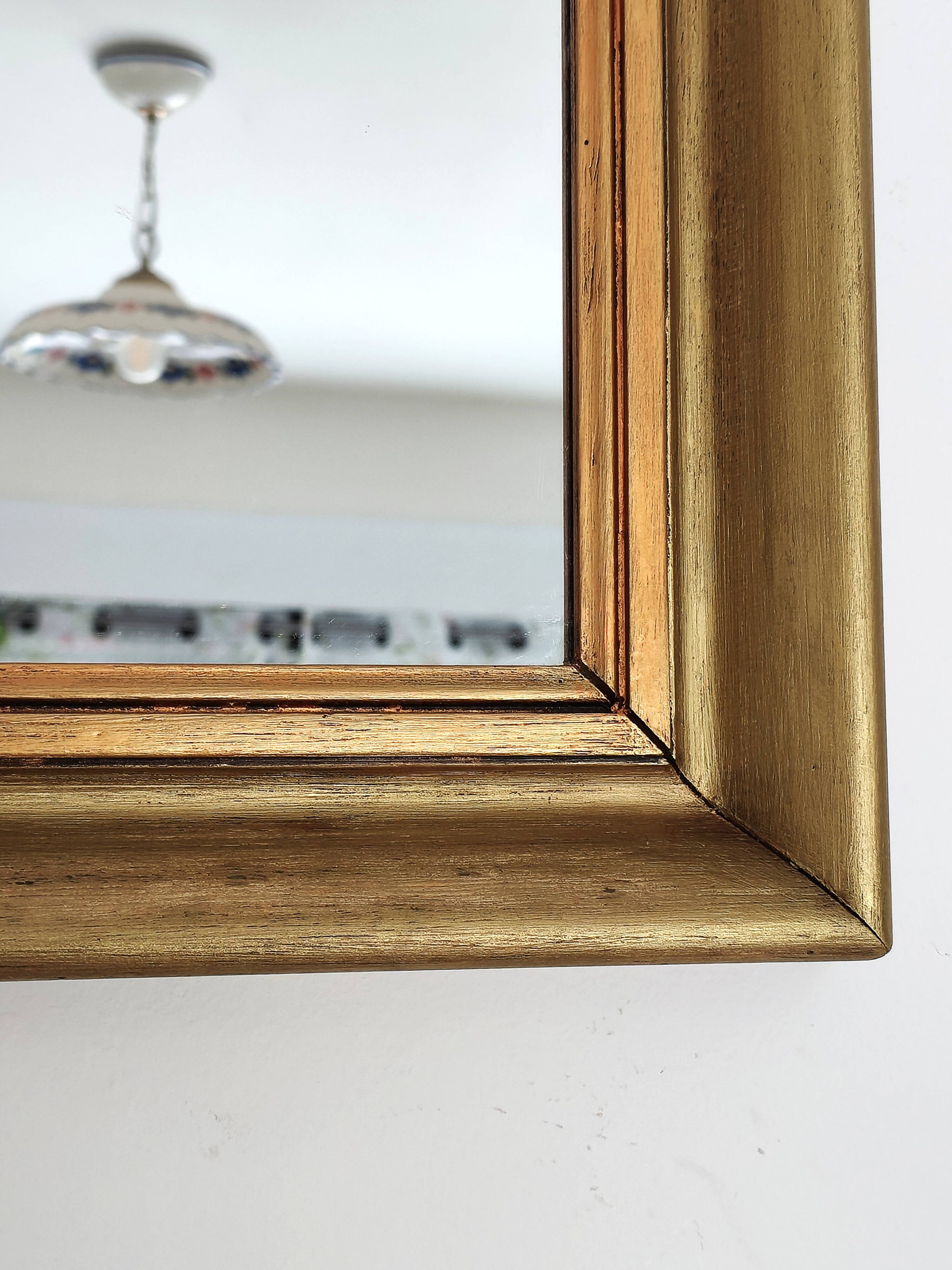 Antique mirror in gilded and copper wood