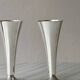 Two silver-coloured lightweight metal flower vases.
