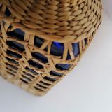 Blue bottle covered with wicker