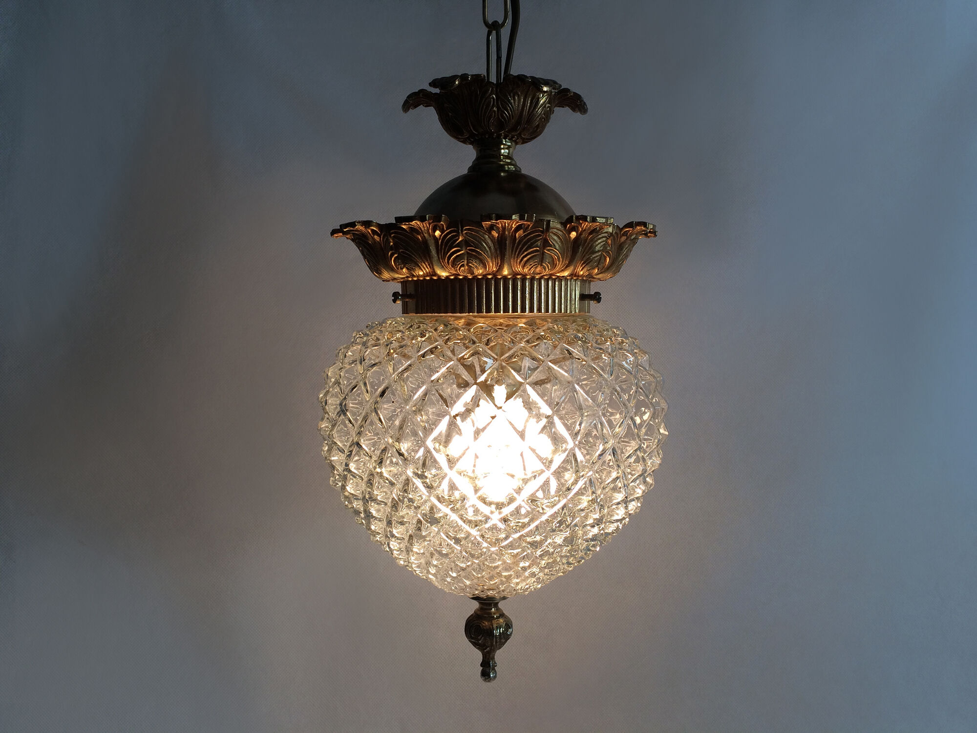 Brass and diamond-tipped chiseled glass globe hanging lamp