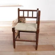 Antique Dutch oak corner chair with turned spindles and new rush seat