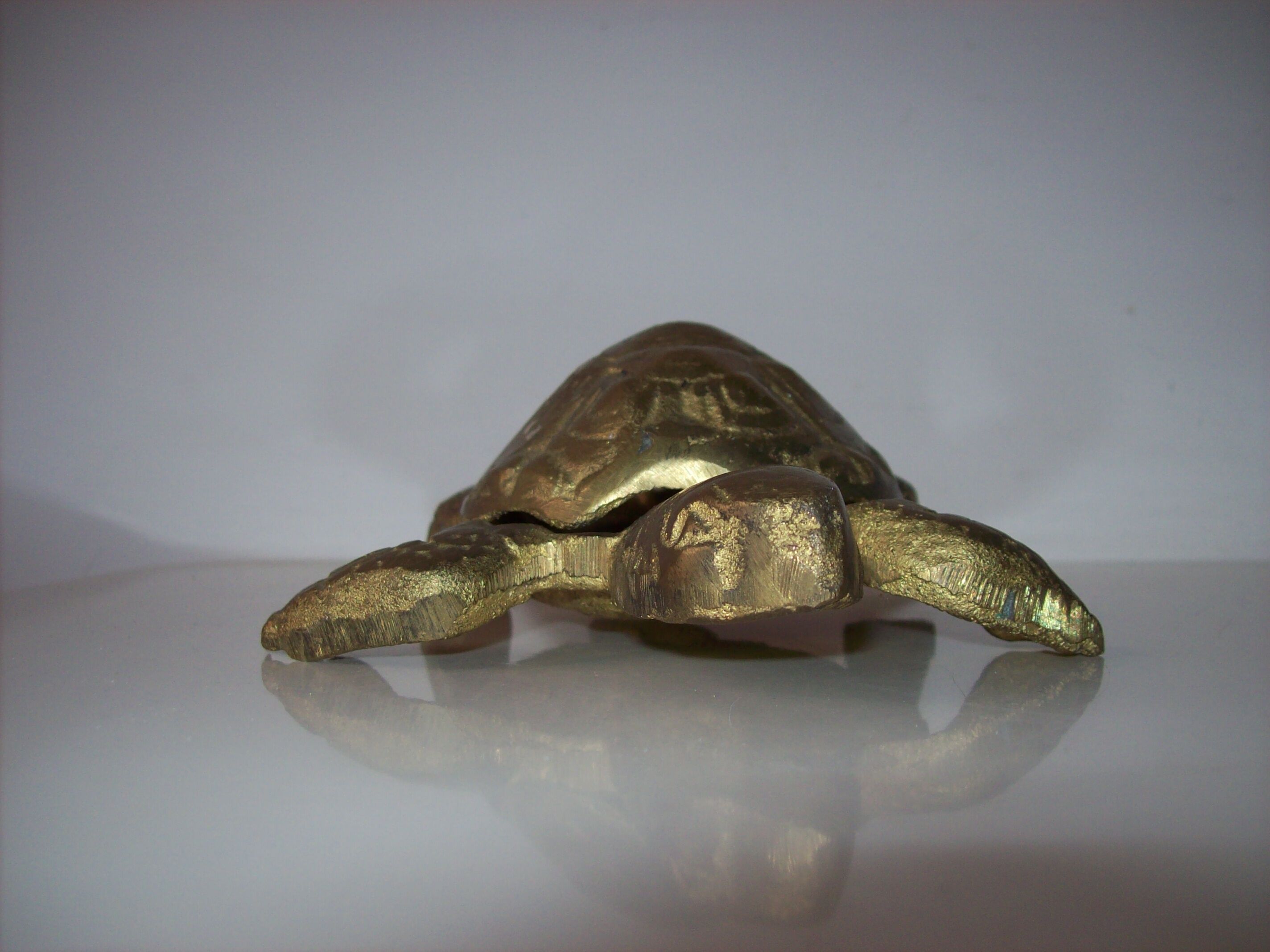 Golden brass ashtray has a turtle-shaped