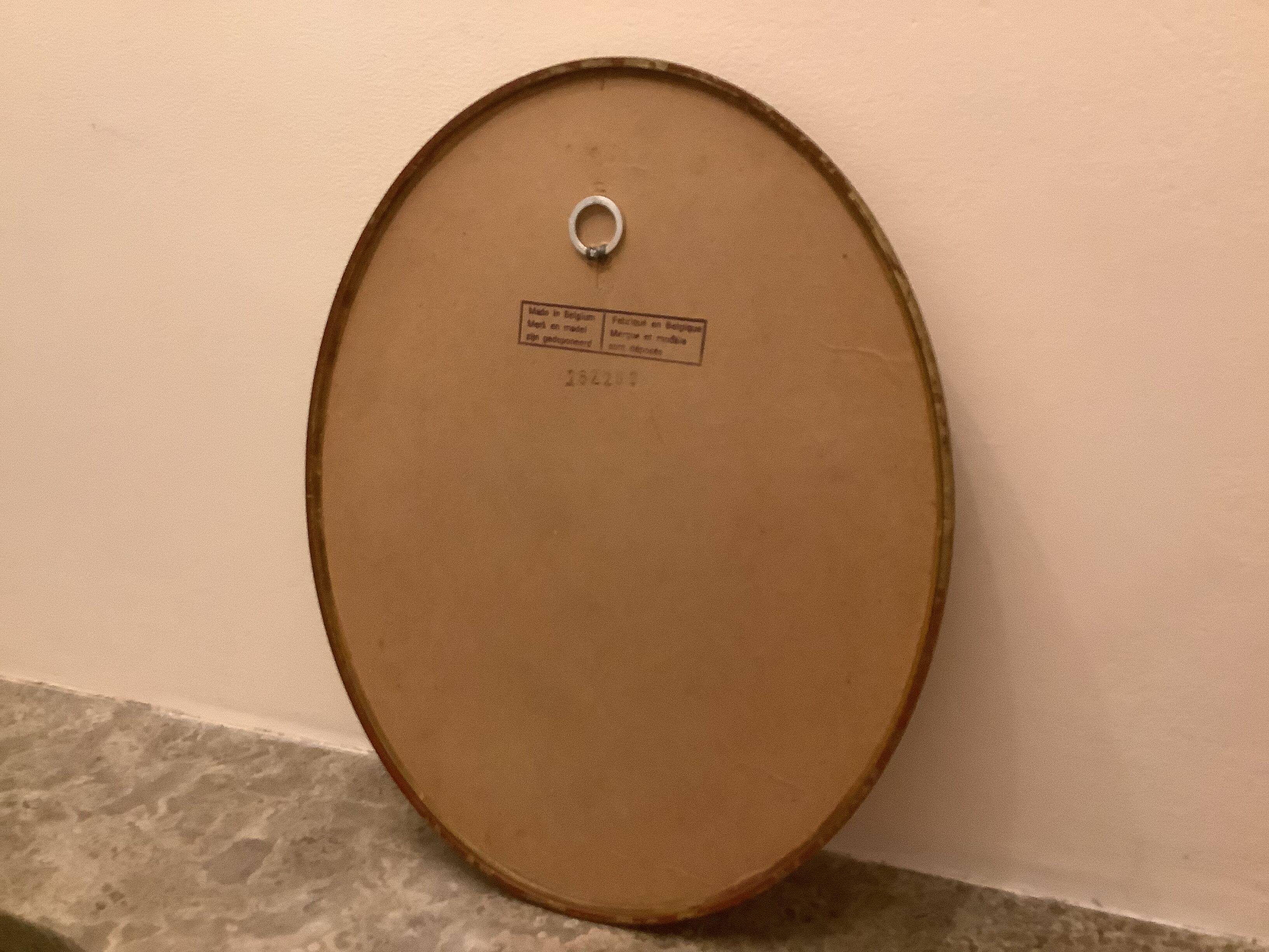 Golden oval mirror