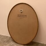 Golden oval mirror