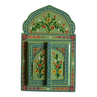 Mirror under shutters with painted flower decoration