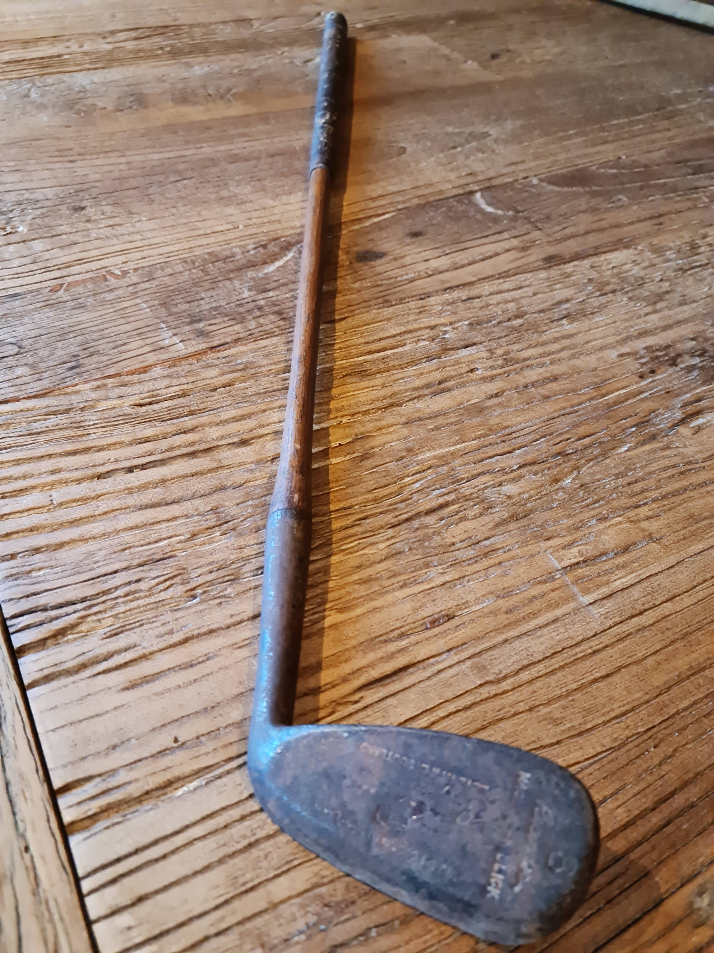 Wood, leather and metal golf club