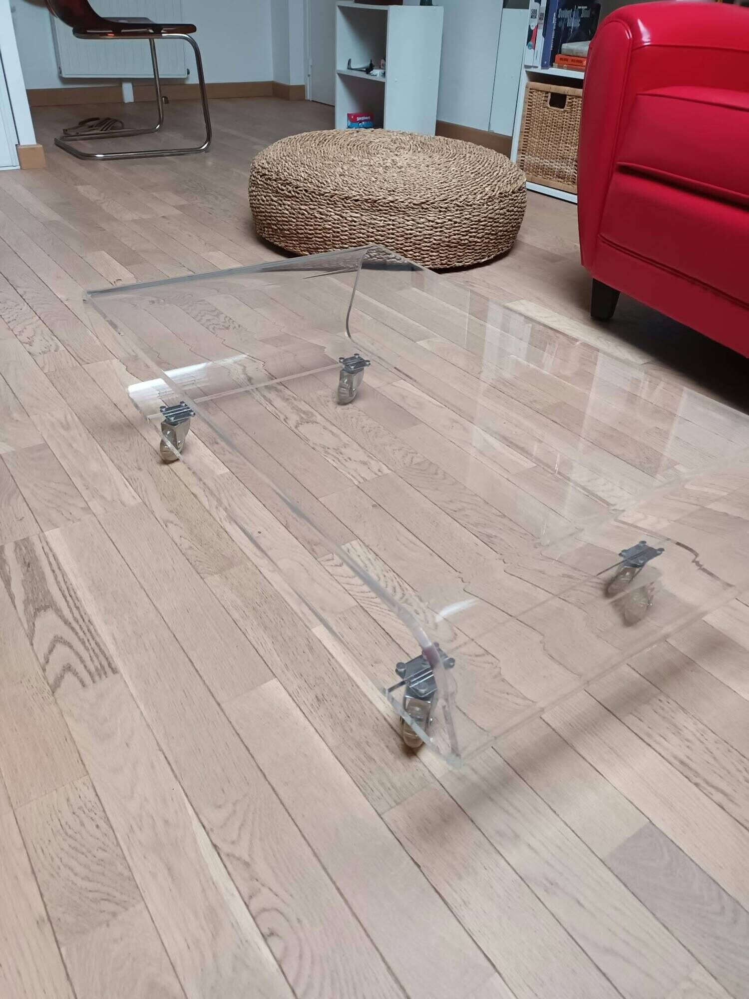 Design coffee table from Habitat in transparent plexiglass, mounted on wheels.