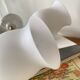 Pair of torch wall lights in brass, white glass and porcelain.