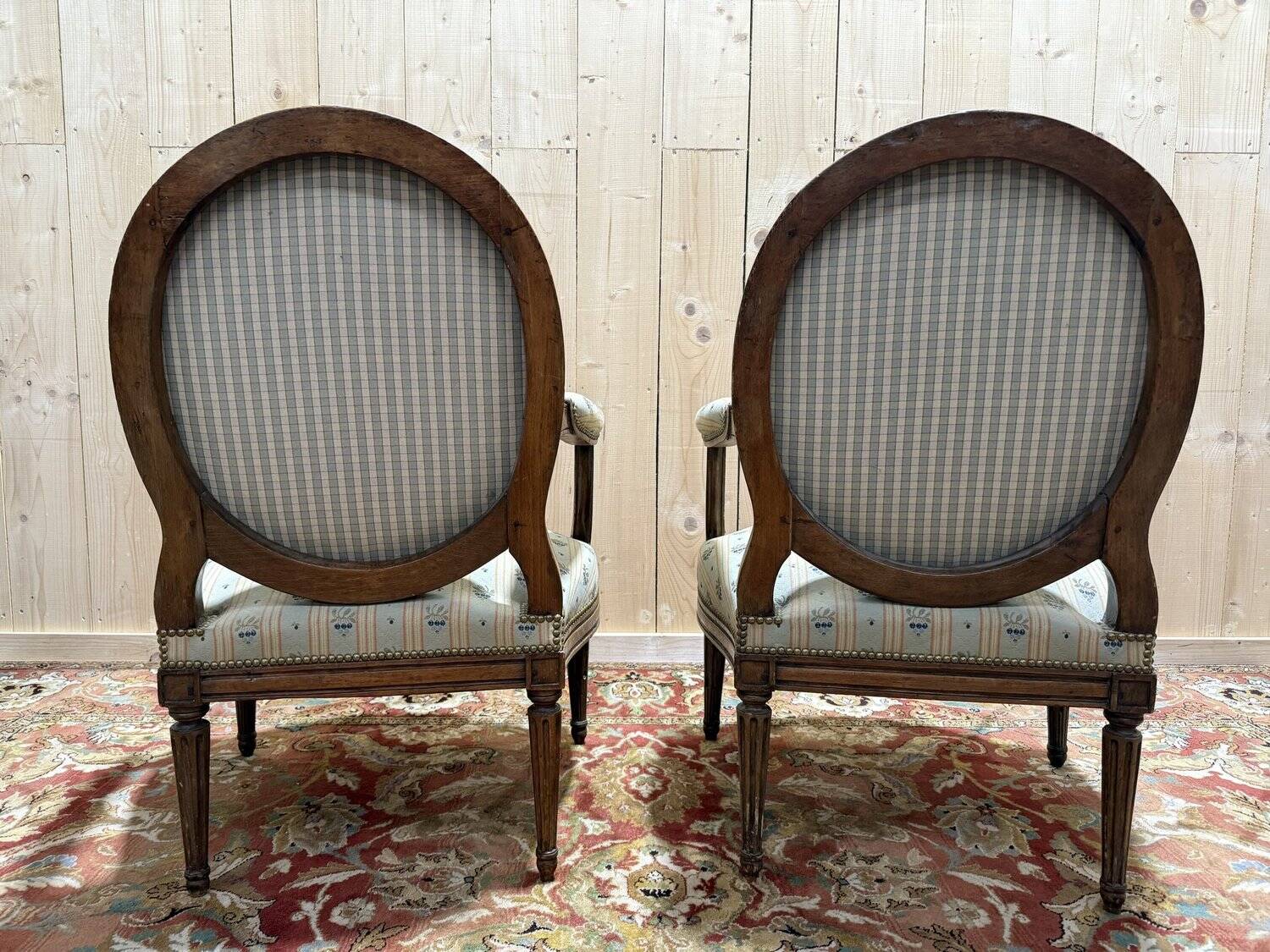 Pair of cabriole armchairs with medallion backs from the Louis XVI period, stamped OT.