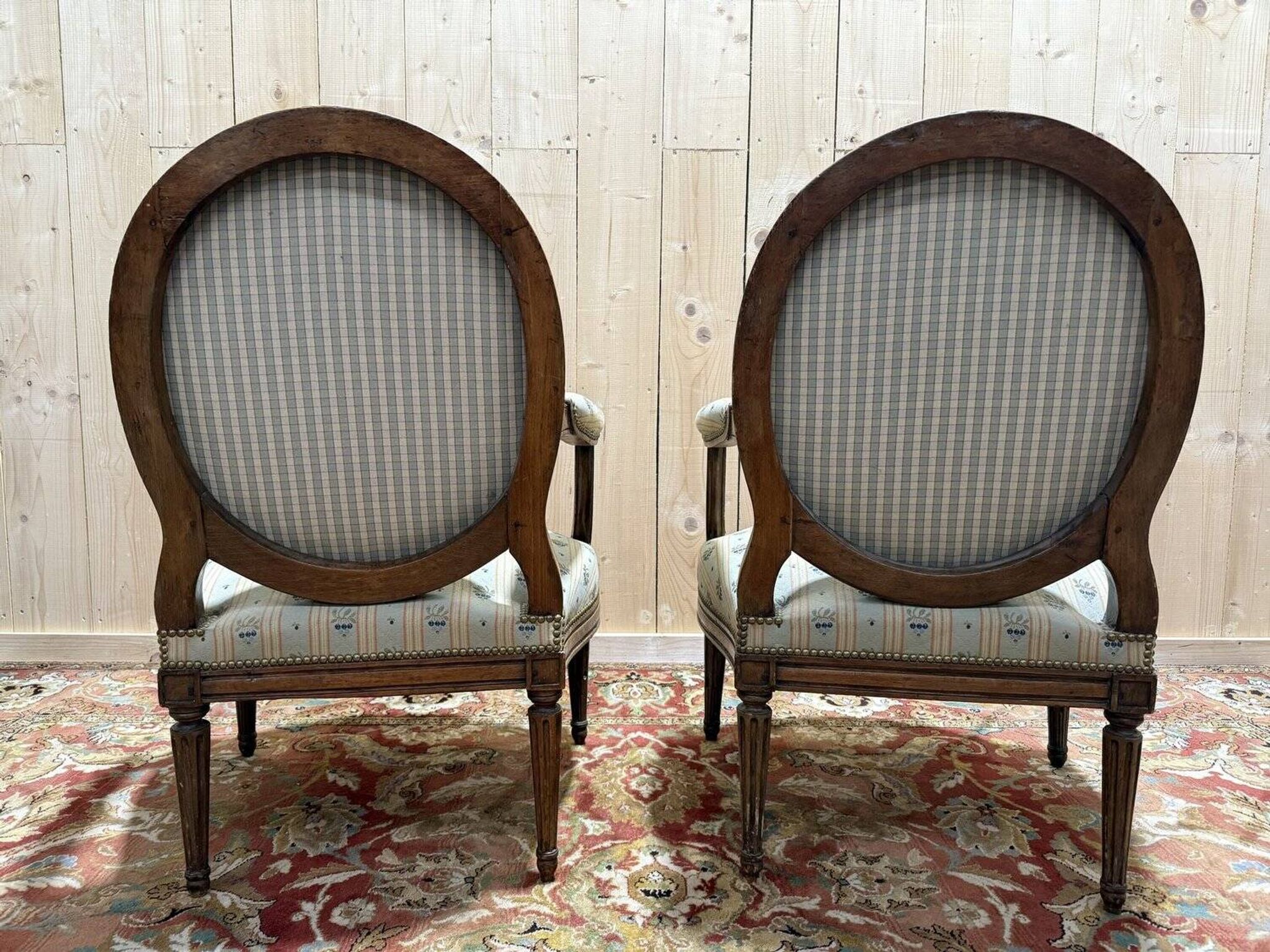 Pair of cabriole armchairs with medallion backs from the Louis XVI period, stamped OT.
