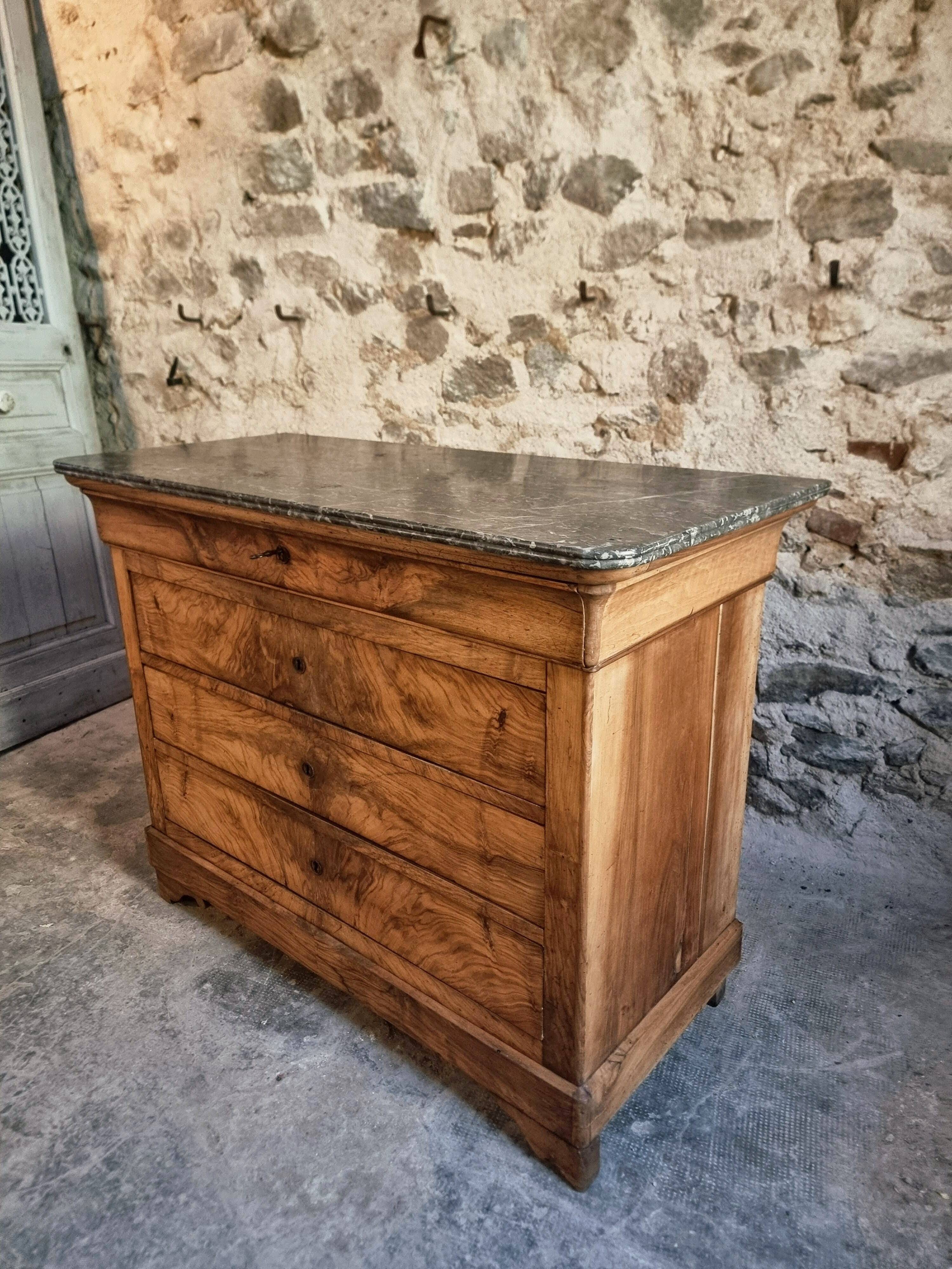 French antique walnut commode with a dark grey marble top, circa 1830–1860.