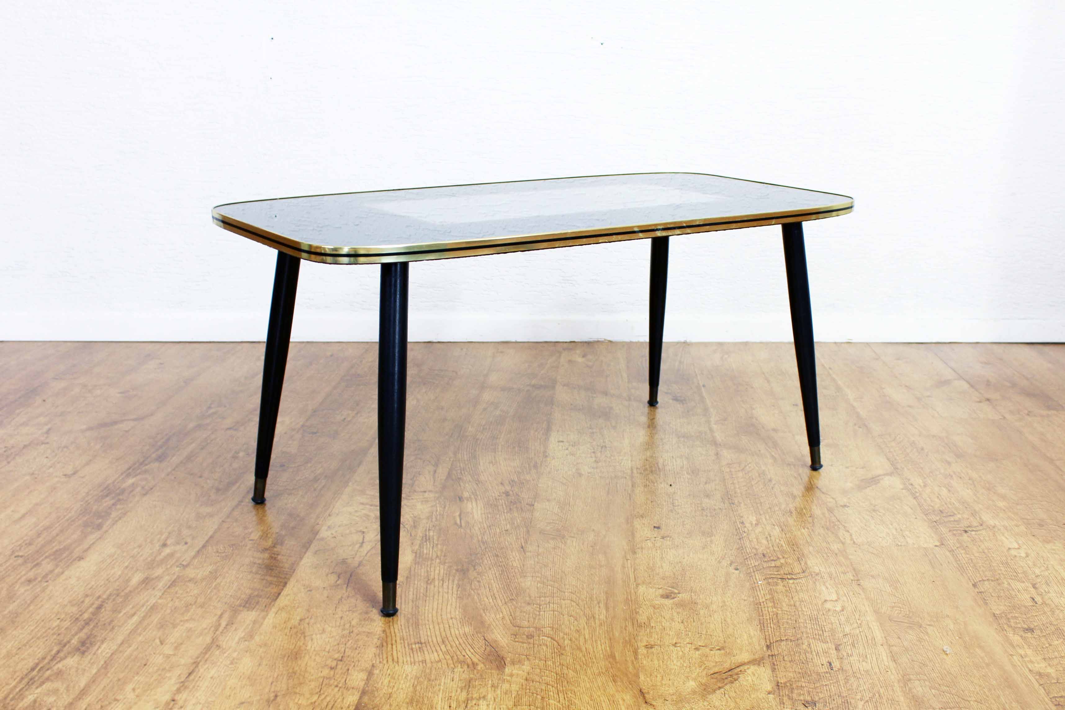 Low table with compass feet with decorative cabinet