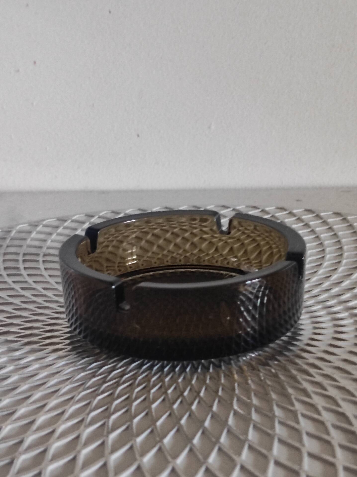 Dark smoked glass ashtray from the 1970s.