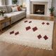 Minimalist cream Berber rug with red diamonds.