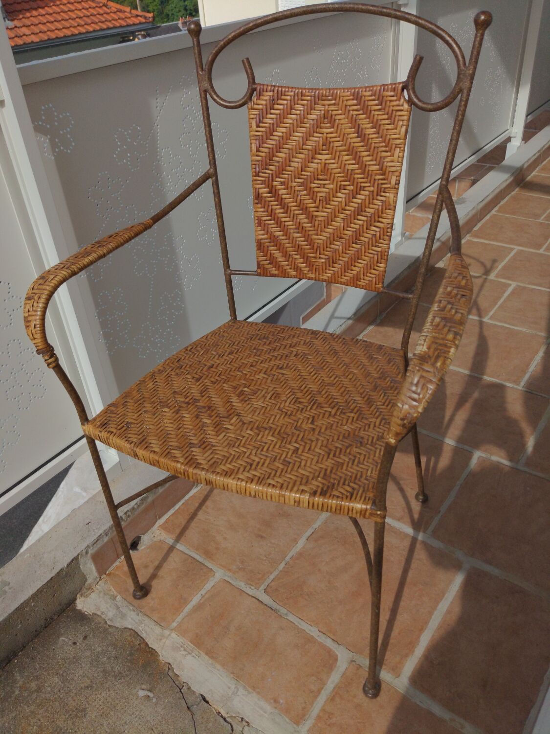 Wicker armchair and wrought iron
