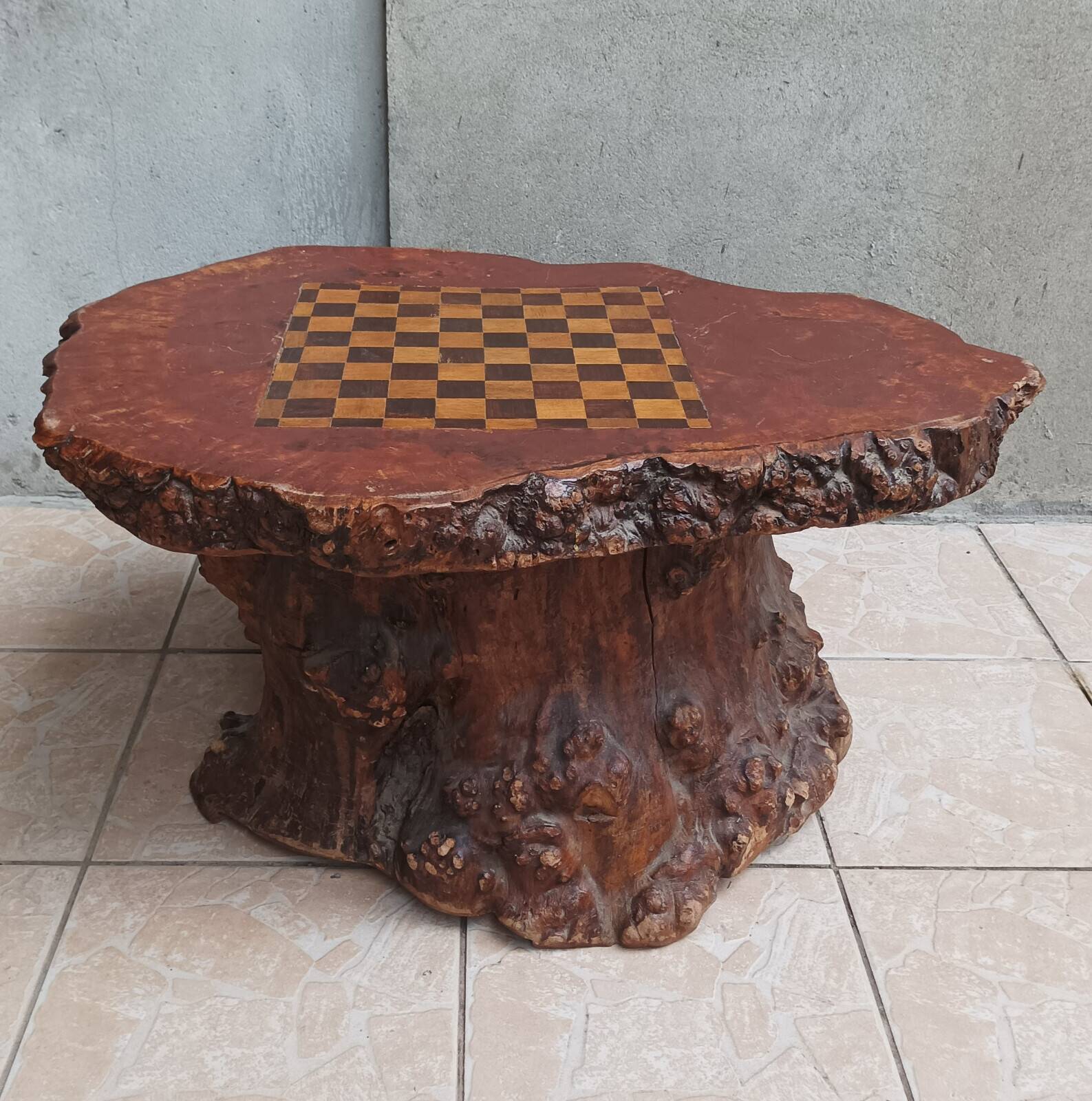 Brutalist chessboard coffee table made from tree stump.