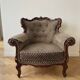 Baroque armchair in carved wood and geometric fabric.