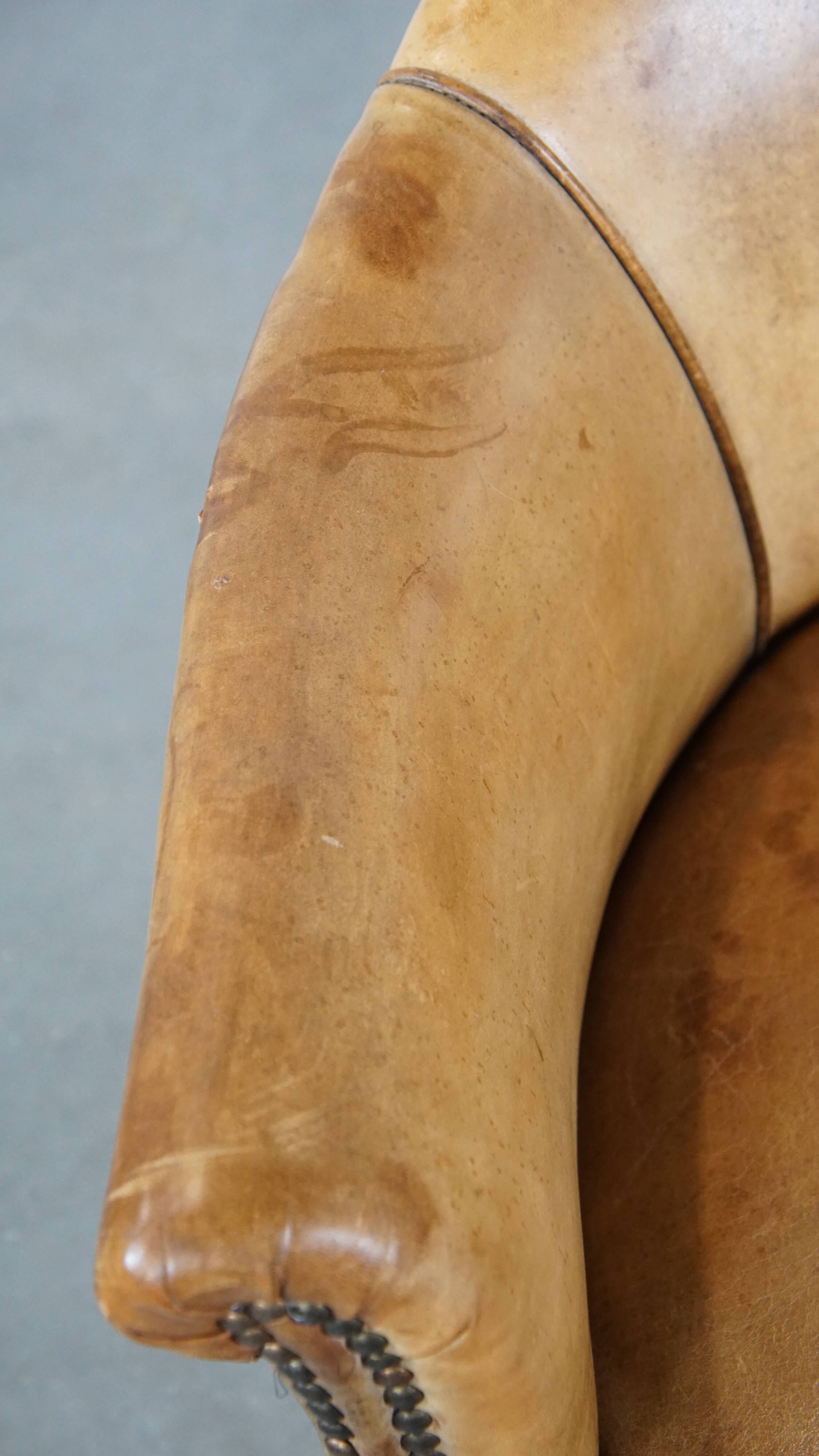 Antique sheep leather club chair/armchair on wheels