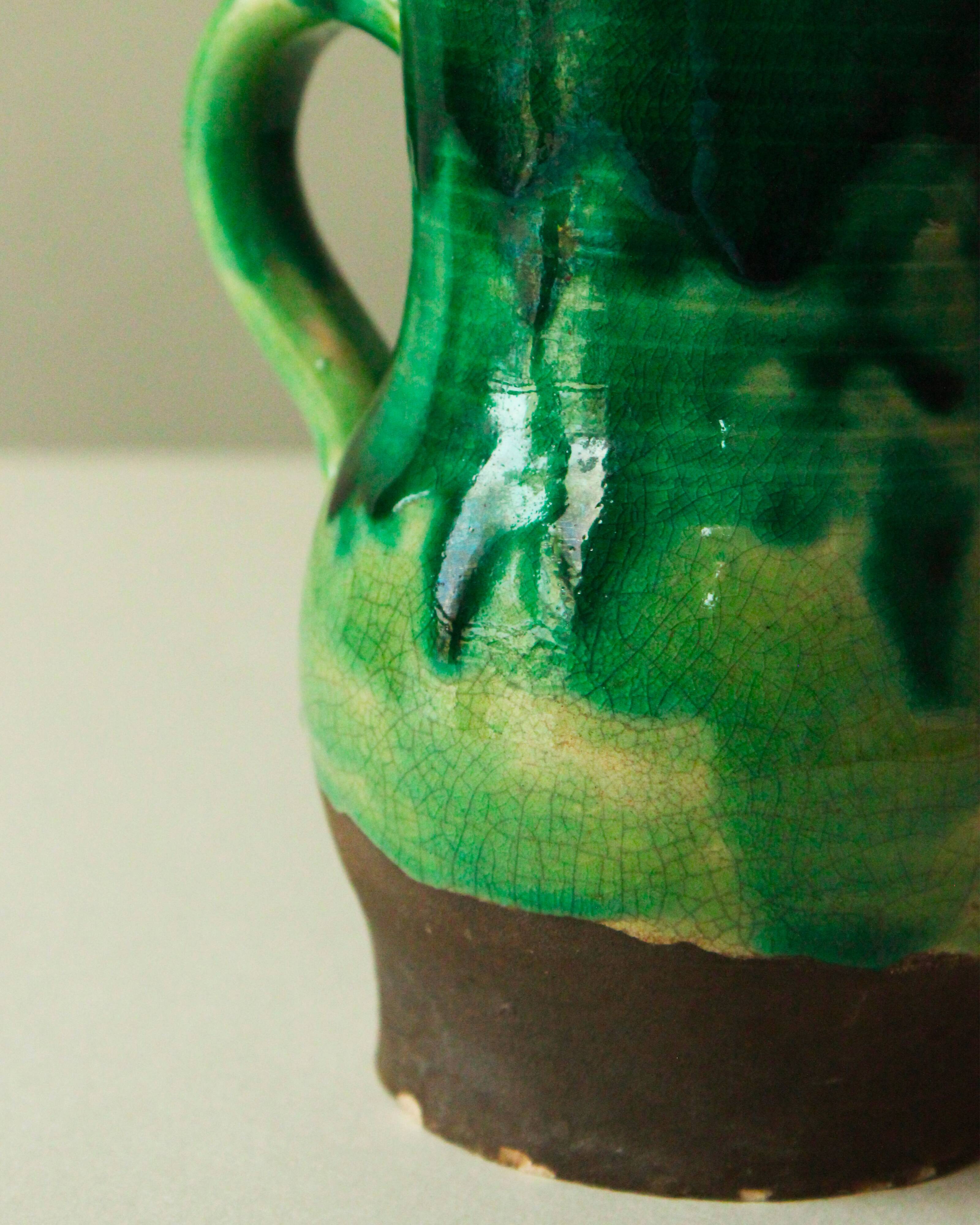 Glazed ceramic pitcher in green and brown by the potter Pierre Roulot.