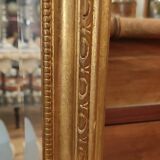 Old beveled mirror with gilded wood frame 20th century