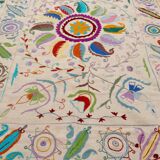 White suzani kilim rug with embroidered multi-colored patterns