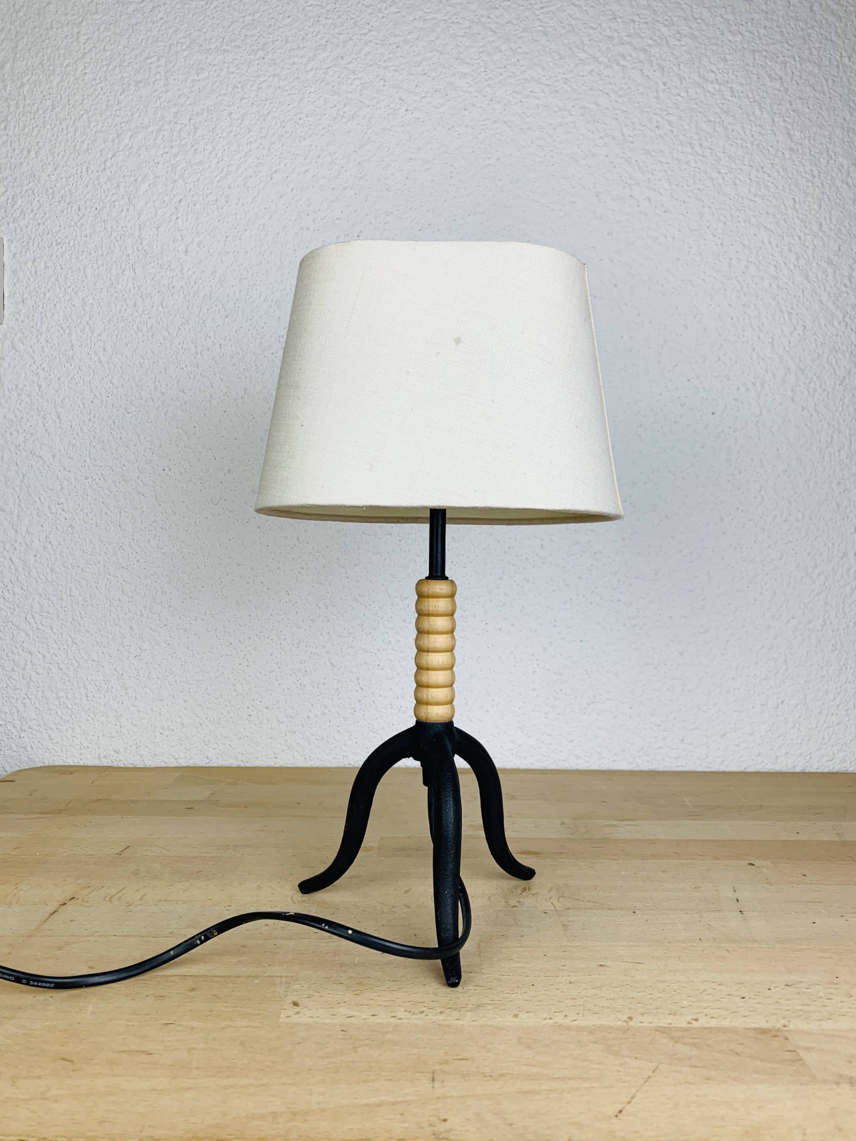 Wrought iron and wood tripod lamp