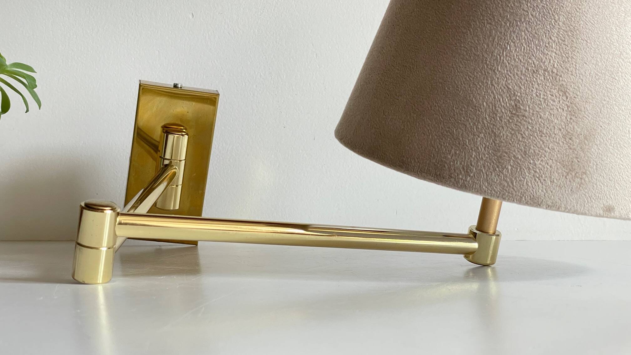 articulated brass and velvet wall light