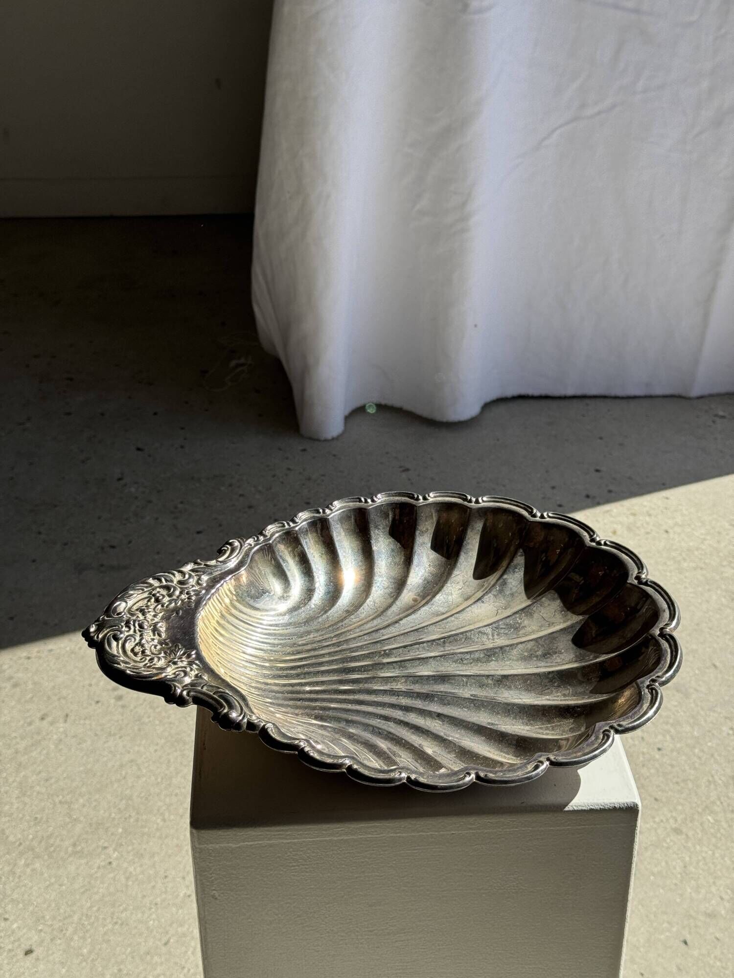 Large antique silver-plated bowl in the shape of a shell.