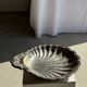 Large antique silver-plated bowl in the shape of a shell.