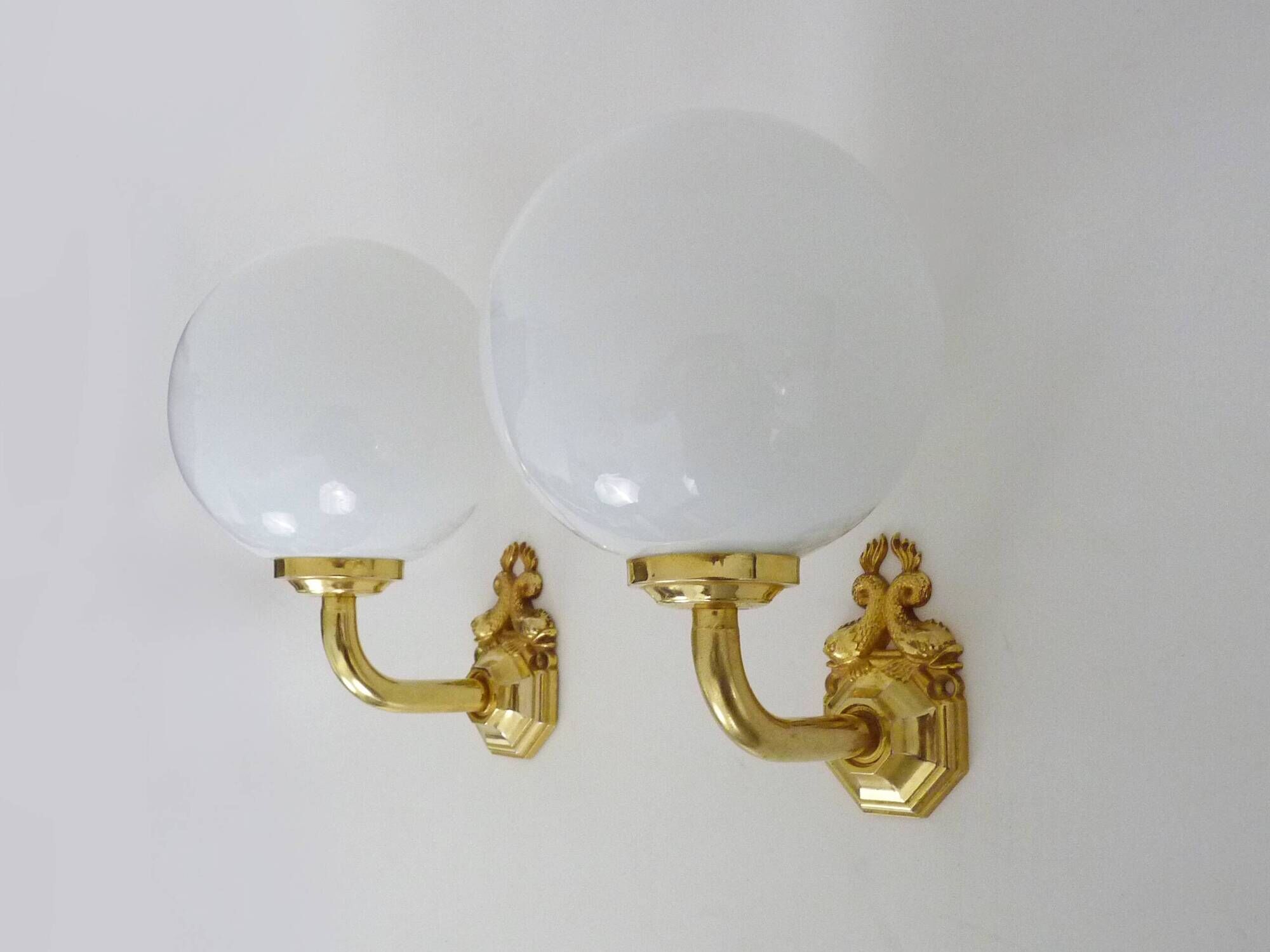 Pair of wall sconces with carp fish, brass and opaline globe.