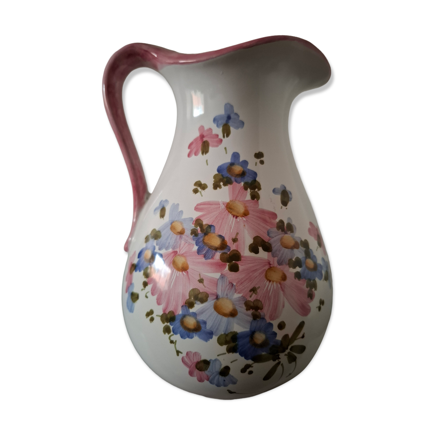 Old ceramic pitcher with floral decoration.