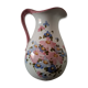 Old ceramic pitcher with floral decoration.